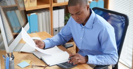 high-angle-view-male-accountant-checking-financial-document