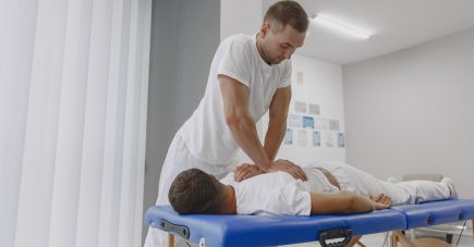 man-medical-office-physiotherapist-is-rehabilitating-back