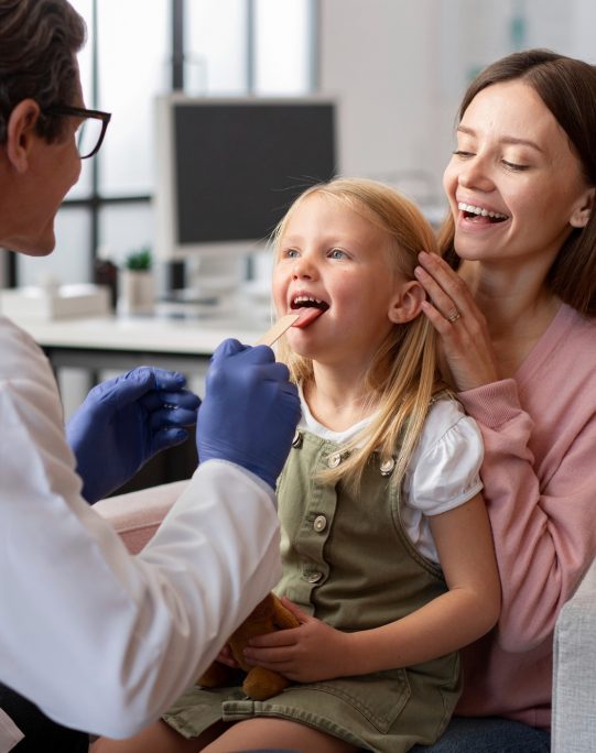young-girl-with-her-mother-doctors-office-physical-examination