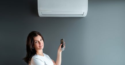 beautiful-girl-stands-air-conditioning-stream-fresh-cold-air-against-gray-wall-concept-heat-cool-air-cooling-freshness