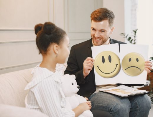 little-girl-having-session-with-pschoterapist-man-giving-test-with-pictures-talking-with-school-girl-childhood