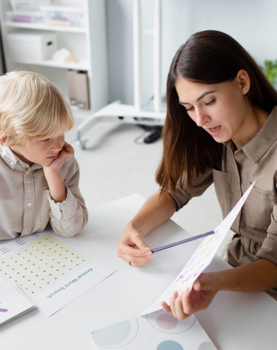 woman-doing-speech-therapy-with-little-blonde-boy
